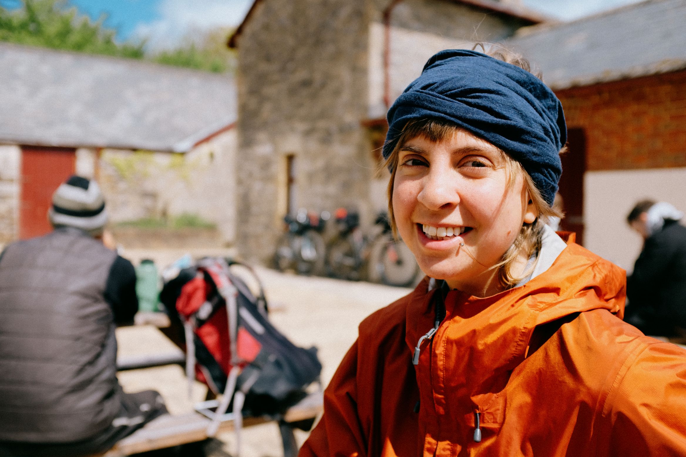 Stopped in a stone farmyard, bikes leaned against the wall behind