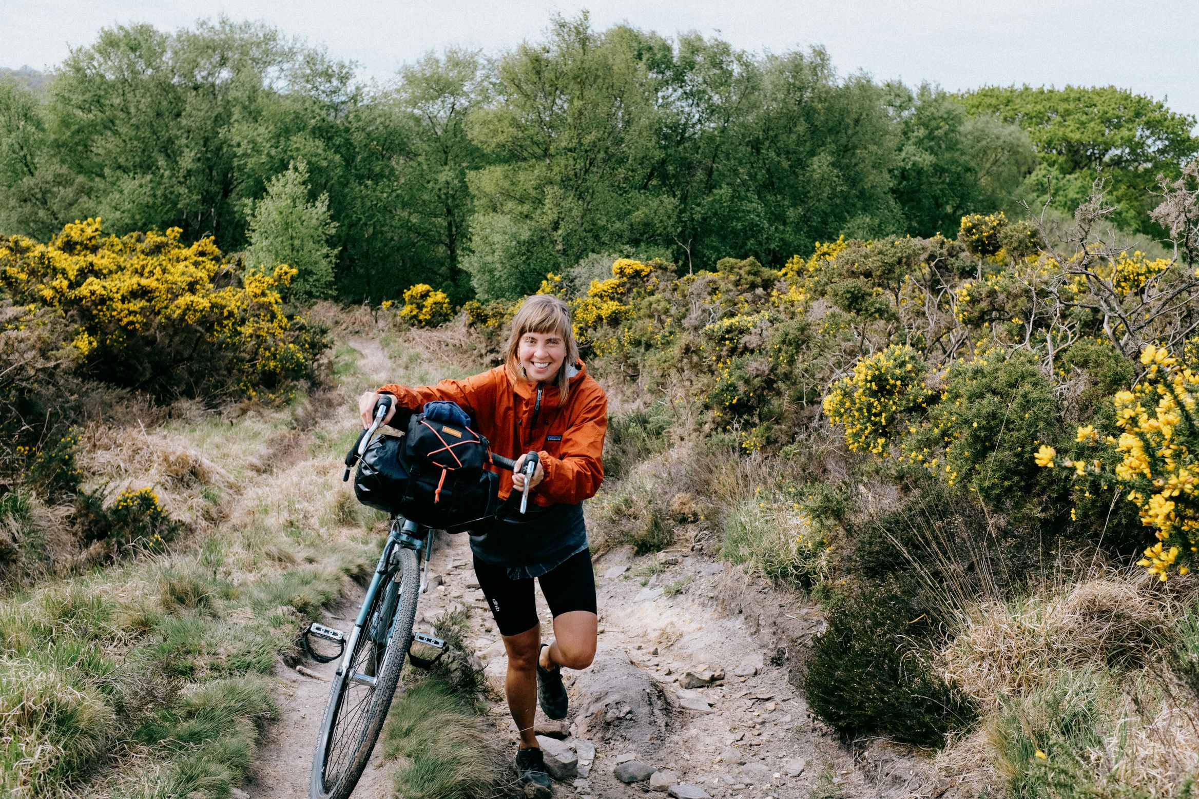 Running the bike up a rise through the gorse