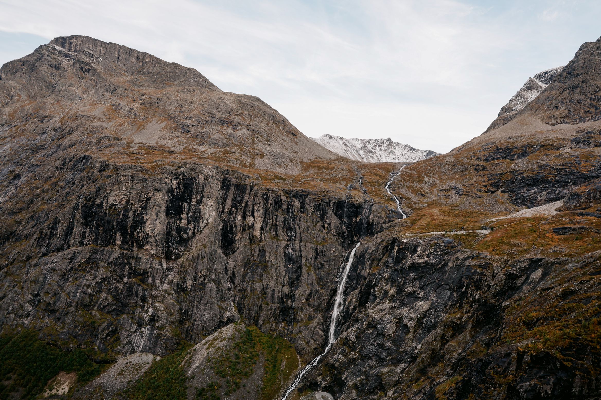 Stigfossen dropping down the black cliff beside the Trollstigen road