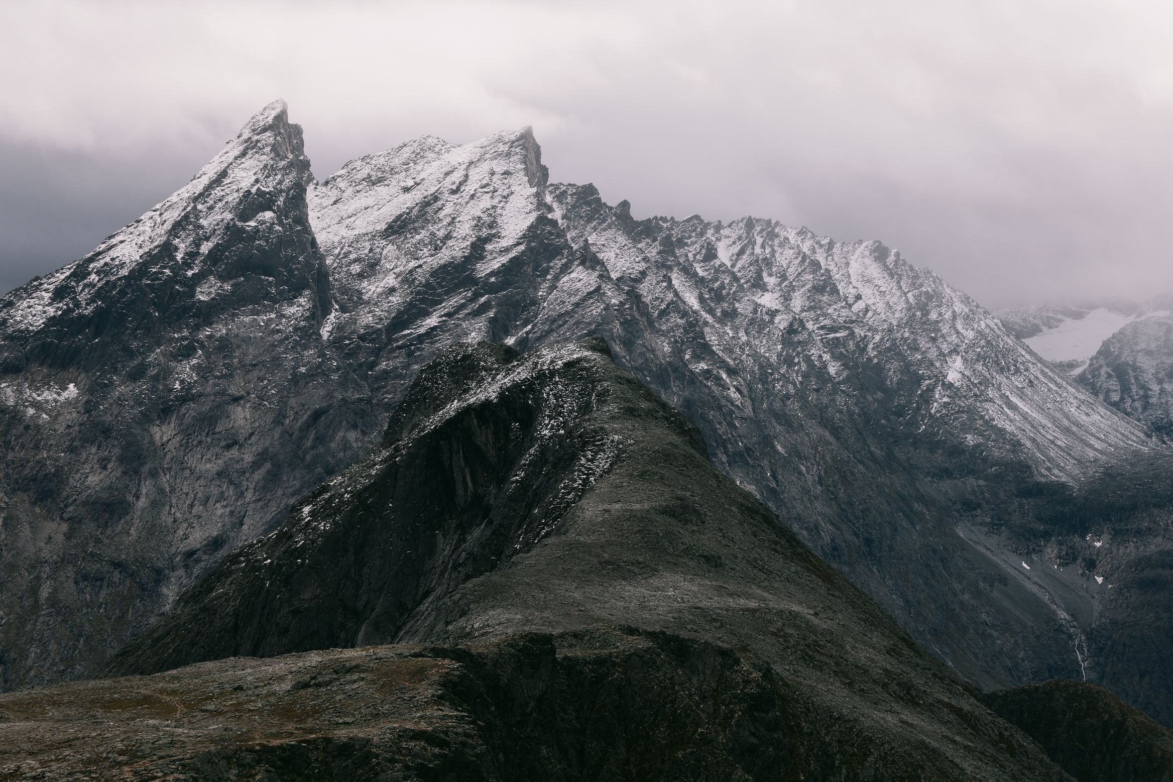 Snow lying fresh on the serrated ridgeline across the valley